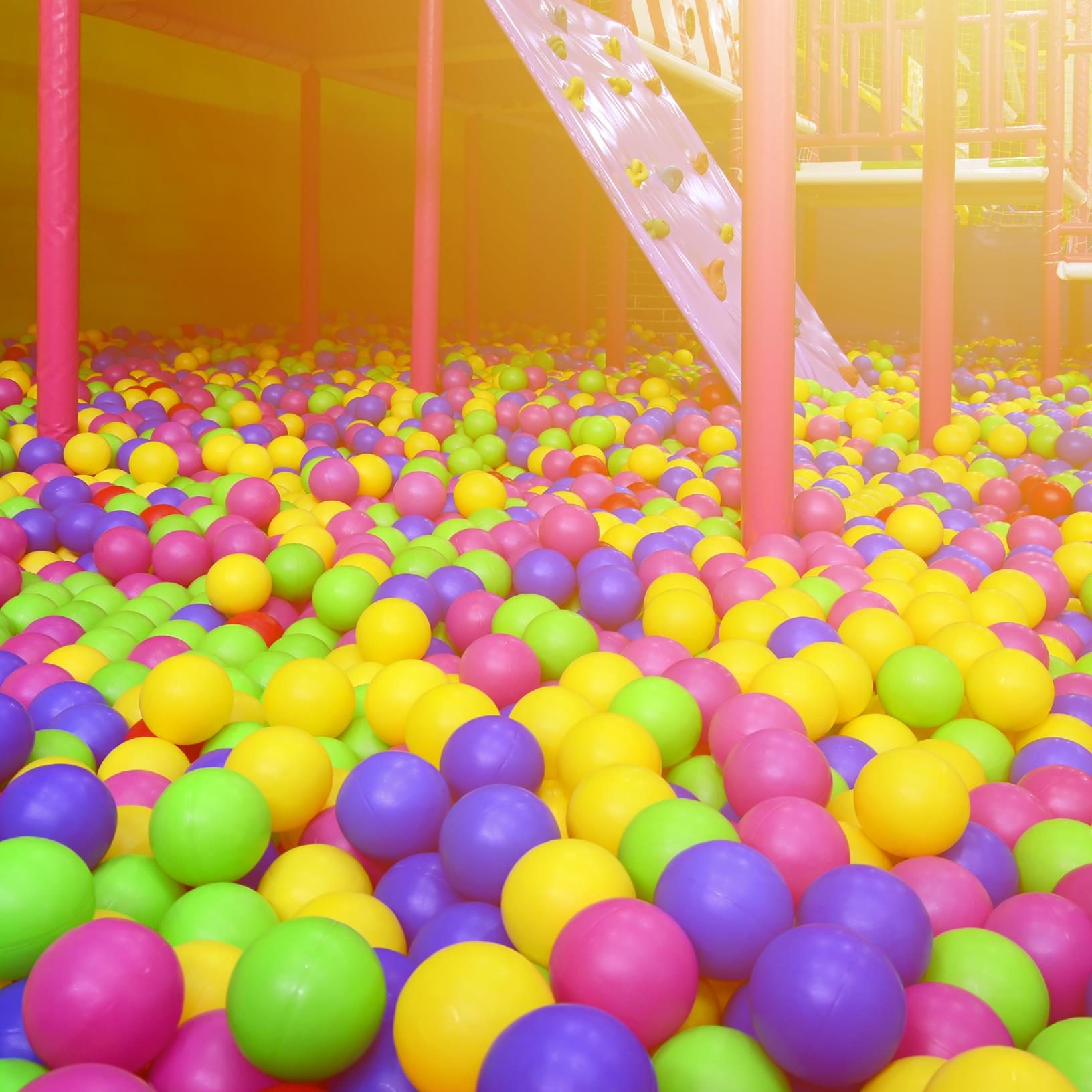 Many colorful plastic balls in a kids’ ballpit at a playground